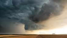 farmland with a storm cloud lingering above