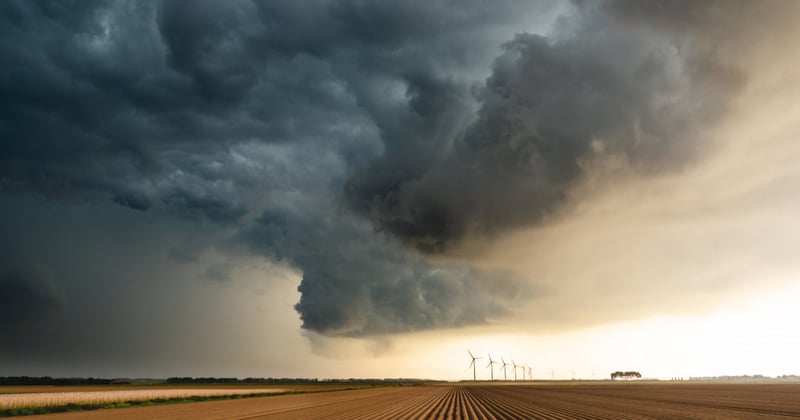 farmland with a storm cloud lingering above